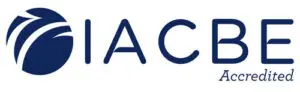 The image displays the logo of the IACBE (International Accreditation Council for Business Education), featuring a blue circular design with white abstract lines on the left side, followed by "IACBE" in blue text and "Accredited" in smaller, italicized gray text.